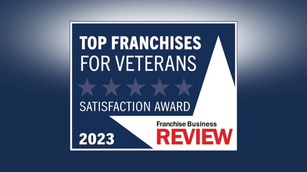 Franchise Business Review 2023 Top Franchises for Veterans award badge on a navy background.