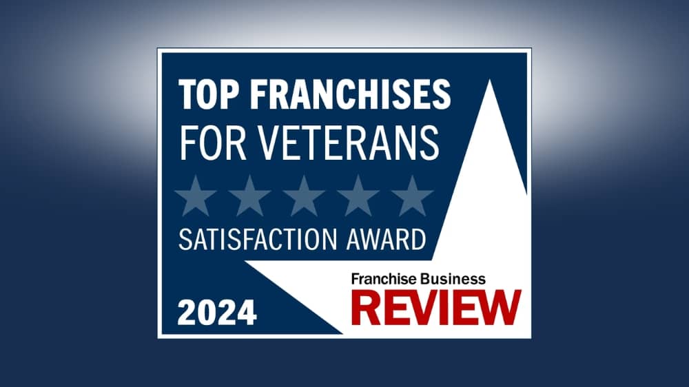 Franchise Business Review 2024 Top Franchises for Veterans award badge on a navy background.