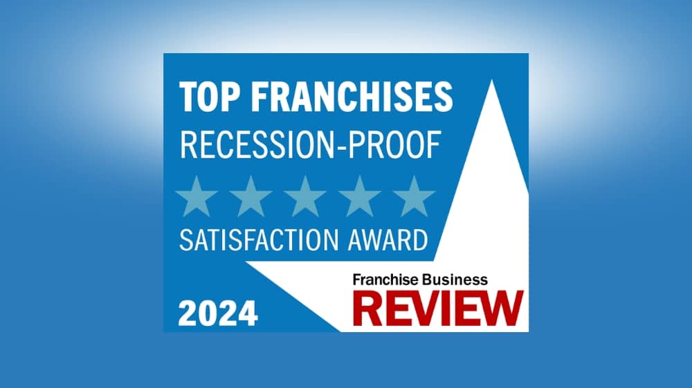 Franchise Business Review 2024 Top Recession-Proof Franchises award badge on a blue background.