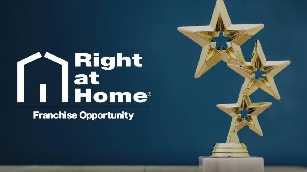 White Right at Home logo on a blue background with a gold star trophy off to the right side