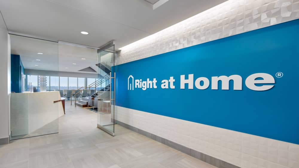 Blue wall of an office that says "Right at Home"