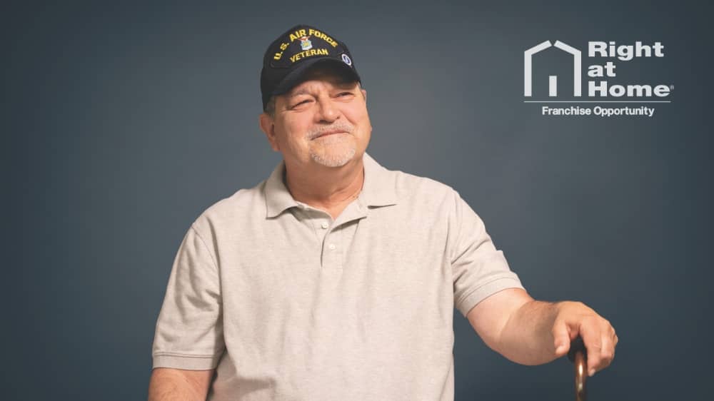 Male veteran sitting in front of a dark grey background