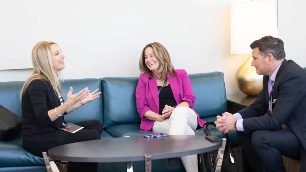 Margaret Haynes chatting with Brady Schwab and Right at Home Franchisee