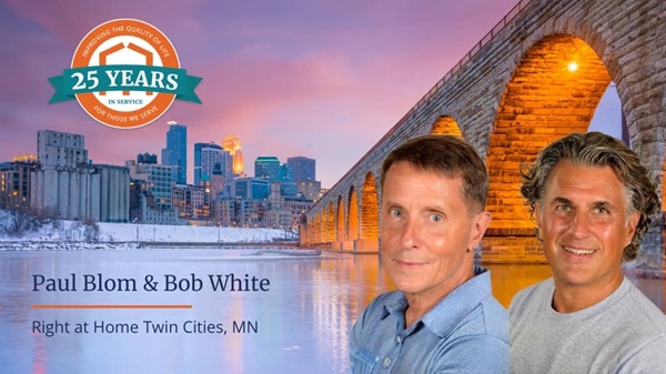 Right at Home franchsiees Paul Blom and Bob White in front of a cityscape of Twin Cities, Minnesota
