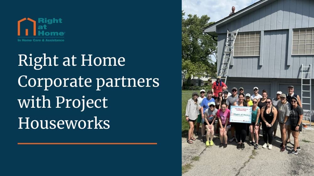 Group of Right at Home employees standing outside of a home that they painted