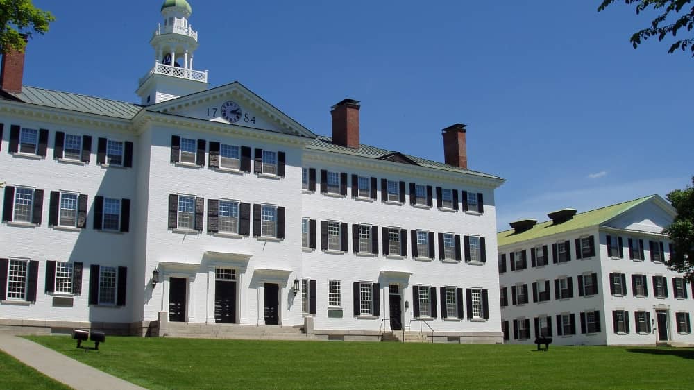 White colonial style building on top of a hill