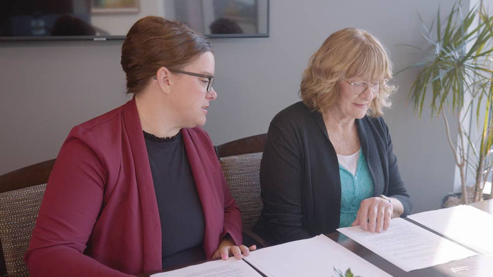 A female Right at Home representative is consulting with a potential senior female client in her home