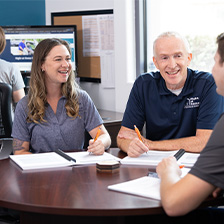 Three Right at Home office staff employees sitting at a table and talking