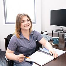 Female Right at Home office staff employee sitting at a desk