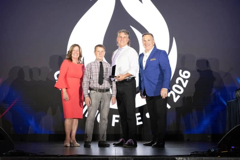 Paul Blom being awarded as an outstanding franchisee by Margaret Haynes and Rod Roberts at Home Improvement 2025